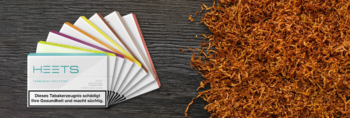 Das Sortiment der Iqos heets neben einem Haufen von American Blend Tabak